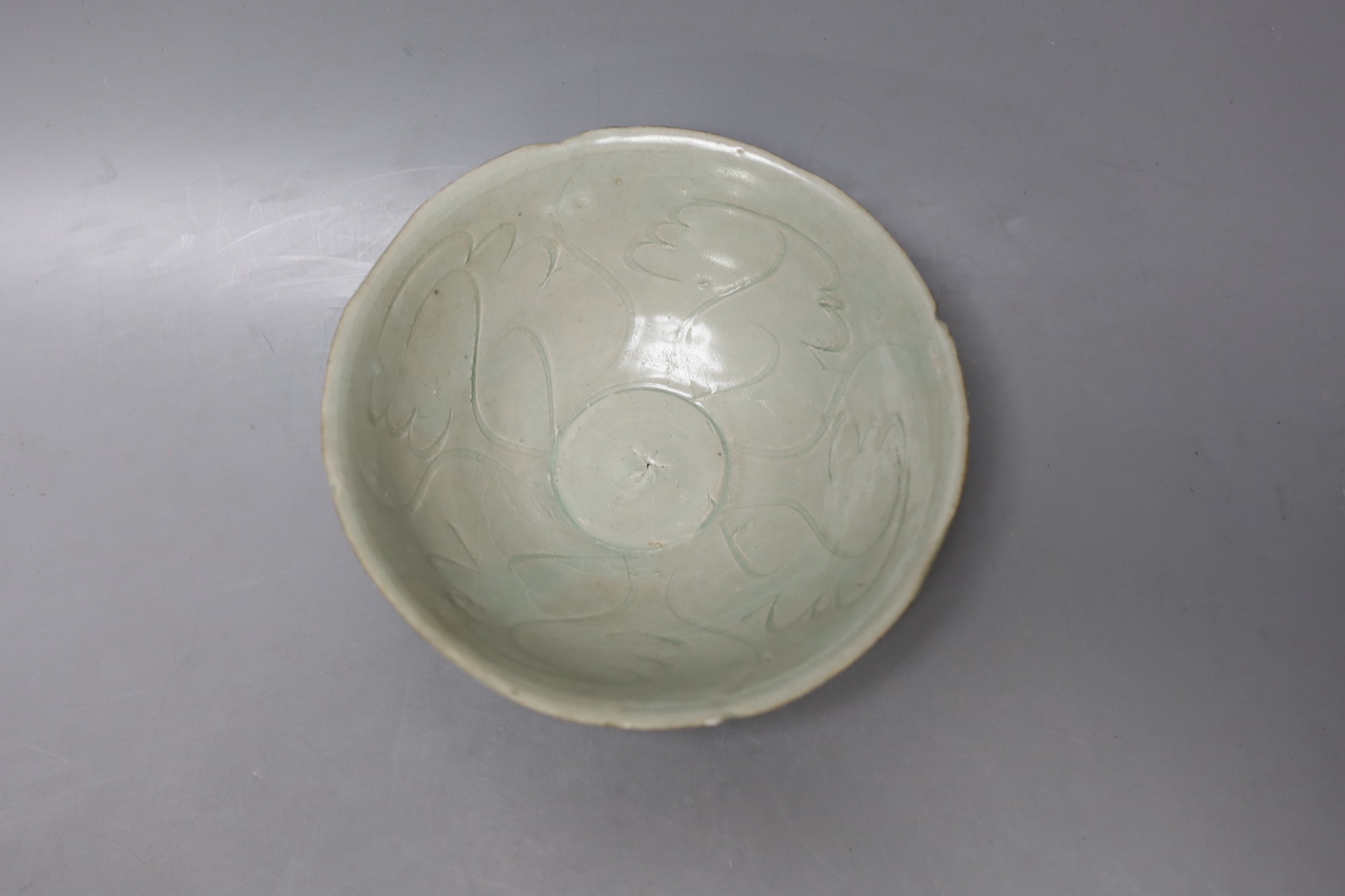 A Chinese incised celadon shipwreck bowl, Song/Yuan dynasty - 16.5cm diameter